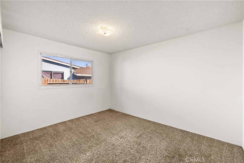 45443 Saigon Avenue Lancaster, CA 93534 - Photo 12 of 20 an empty room with a hallway