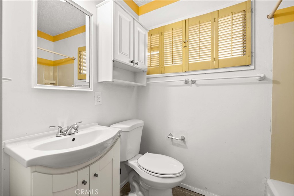 45443 Saigon Avenue Lancaster, CA 93534 - Photo 15 of 20 a bathroom with a sink a toilet and a window