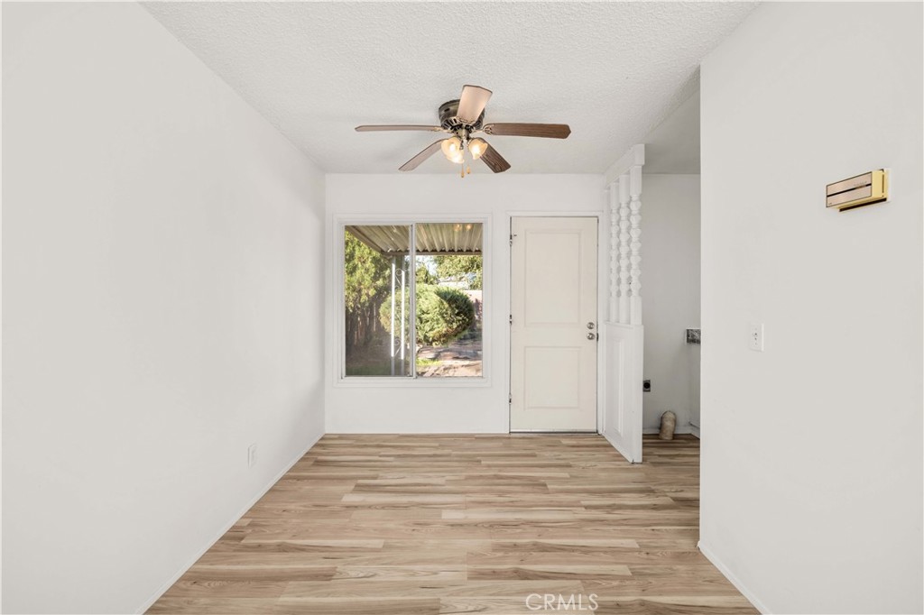 45443 Saigon Avenue Lancaster, CA 93534 - Photo 4 of 20 a view of empty room with wooden floor and fan