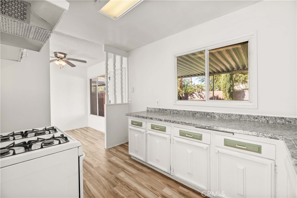 45443 Saigon Avenue Lancaster, CA 93534 - Photo 6 of 20 a kitchen with stainless steel appliances granite countertop a stove and a sink