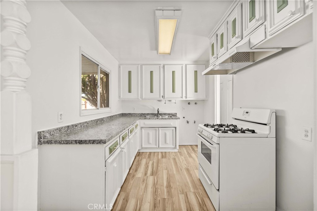 45443 Saigon Avenue Lancaster, CA 93534 - Photo 8 of 20 a kitchen with stainless steel appliances granite countertop a stove and a sink