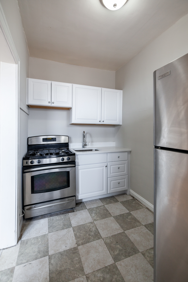 3537 North Troy Street, Unit 3 Chicago, IL 60618 - Photo 4 of 6 a kitchen with appliances cabinets and a counter top space
