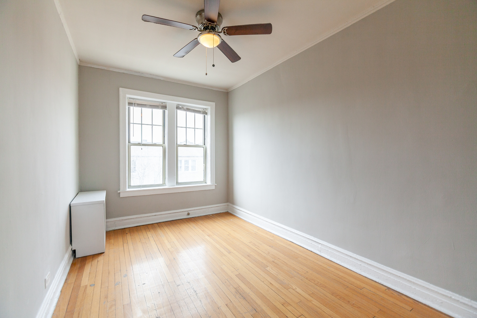 3537 North Troy Street, Unit 3 Chicago, IL 60618 - Photo 5 of 6 wooden floor in an empty room with a window