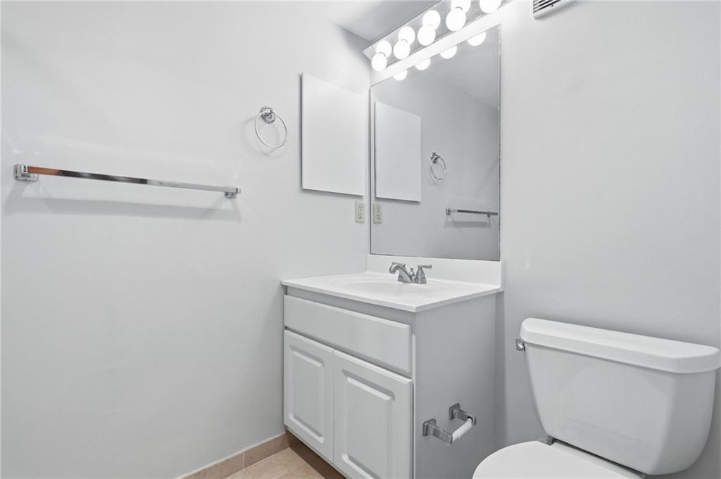 5600 Munhall Road, Unit 202 Pittsburgh, PA 15217 - Photo 14 of 24 a bathroom with a toilet sink and mirror