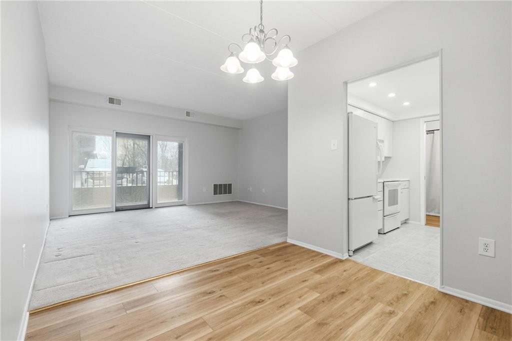 5600 Munhall Road, Unit 202 Pittsburgh, PA 15217 - Photo 4 of 24 a view of an empty room with wooden floor and a window