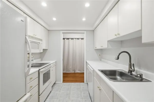 a kitchen with a sink and a refrigerator