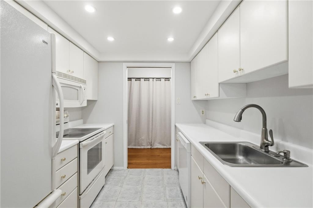 5600 Munhall Road, Unit 202 Pittsburgh, PA 15217 - Photo 8 of 24 a kitchen with a sink and a refrigerator