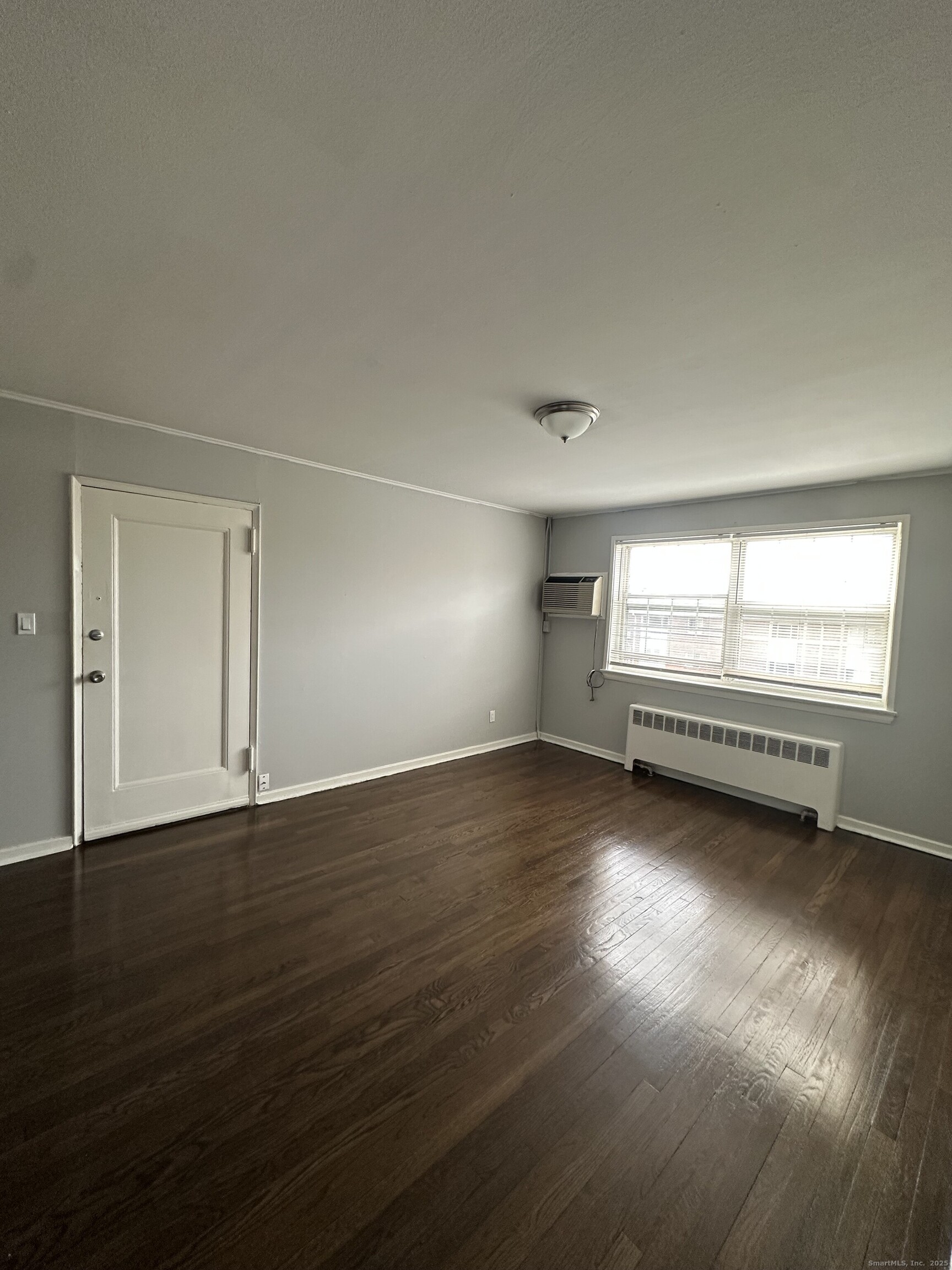 14 Hillcrest Avenue, Unit 14B West Hartford, CT 06110 - Photo 2 of 8 a view of empty room with wooden floor and fan