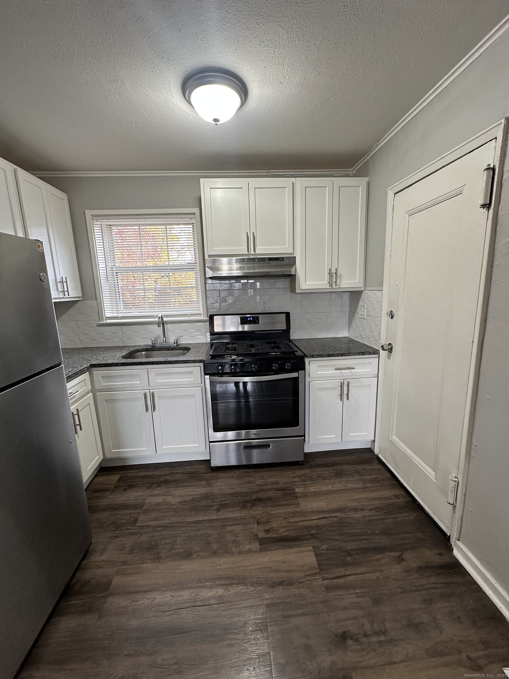 14 Hillcrest Avenue, Unit 14B West Hartford, CT 06110 - Photo 8 of 8 a kitchen with stainless steel appliances a stove a sink and a refrigerator