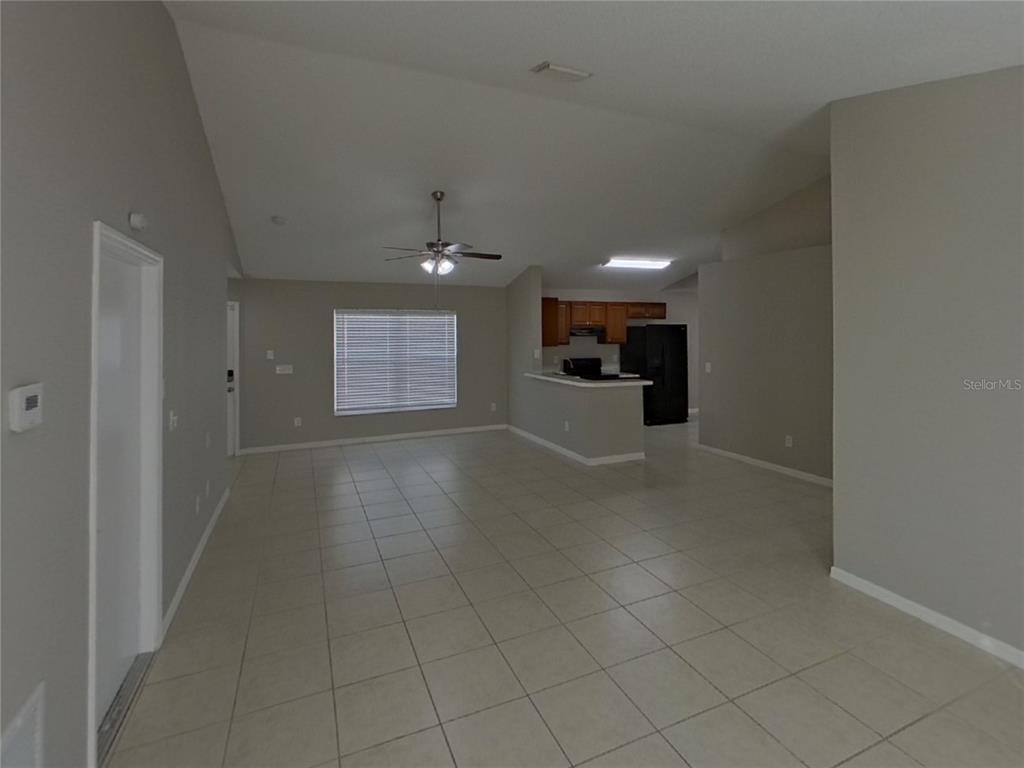 Undisclosed Address Riverview, FL 33578 - Photo 3 of 15 an empty room with fireplace and windows