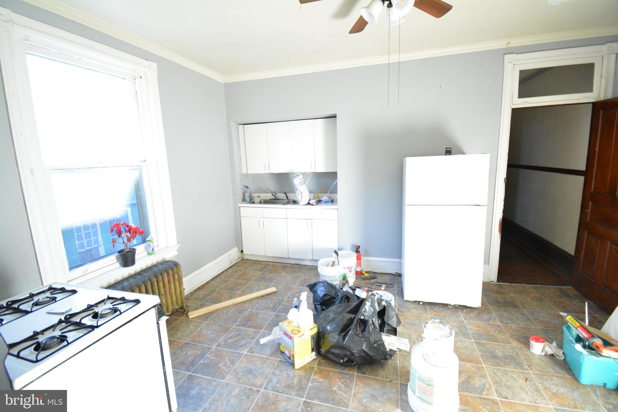 102 Manheim Street, Unit 2 Philadelphia, PA 19144 - Photo 11 of 13 a living room with furniture a refrigerator and a dresser with wooden floor