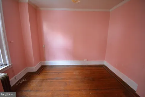 a view of room with window and hardwood floor