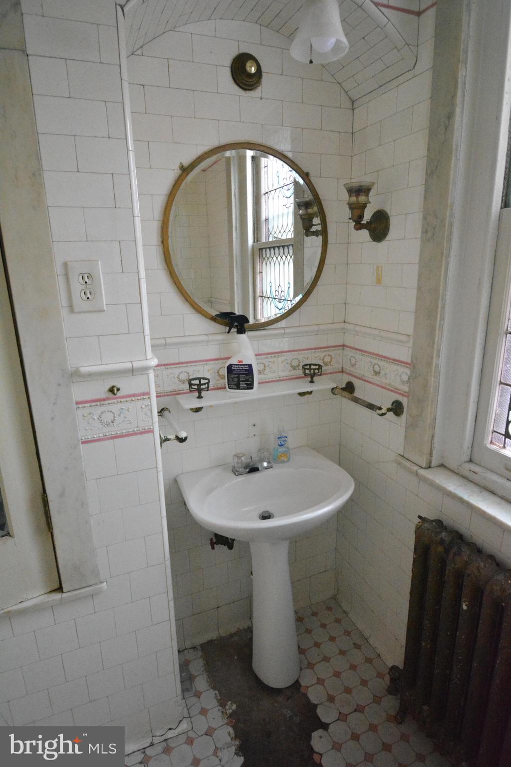 102 Manheim Street, Unit 2 Philadelphia, PA 19144 - Photo 8 of 13 a bathroom with a sink toilet and a mirror