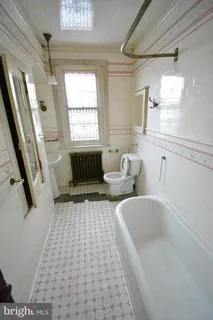 a bathroom with a bathtub sink and window