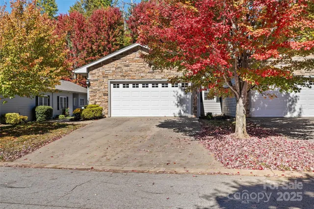 a view of a house with a yard covered in snow