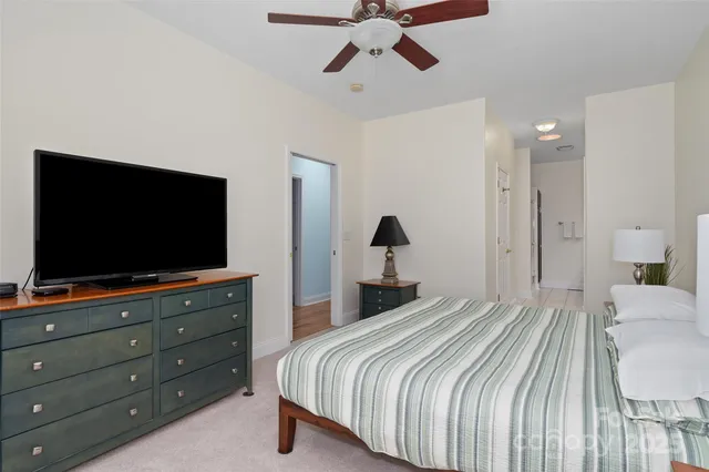 a bedroom with a bed and ceiling fan