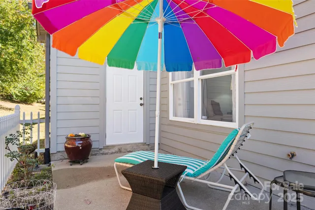 a close up of a white vase with white and yellow flowers