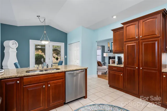 a kitchen with stainless steel appliances granite countertop a refrigerator and cabinets