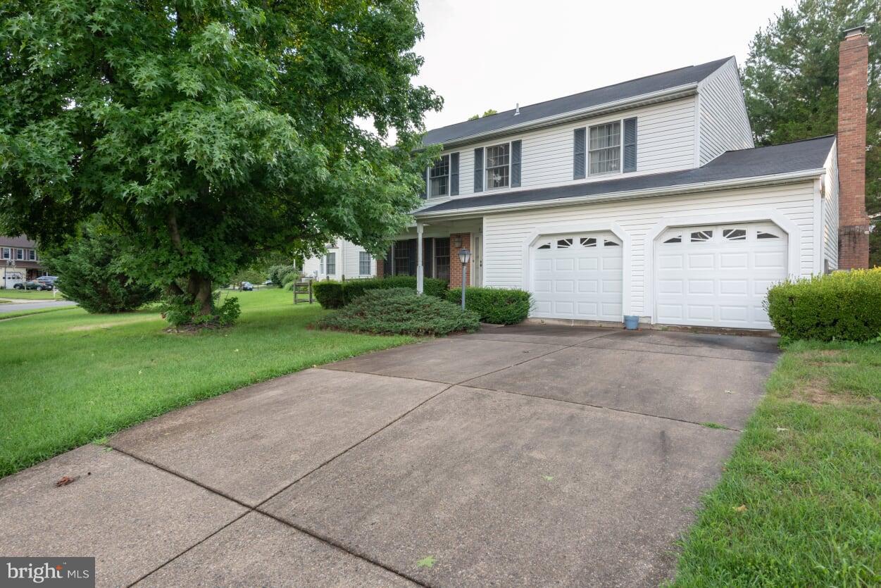 2216 Halter Lane Reston, VA 20191 - Photo 1 of 23 a front view of a house with a yard and garage