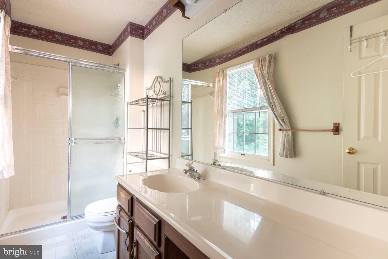 2216 Halter Lane Reston, VA 20191 - Photo 14 of 23 a bathroom with a granite countertop sink toilet and shower