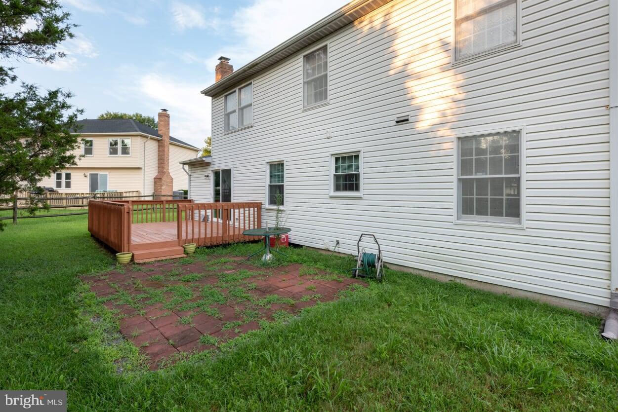 2216 Halter Lane Reston, VA 20191 - Photo 20 of 23 a backyard of a house with barbeque oven and plants