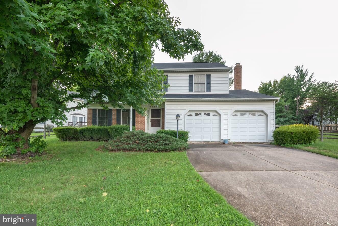 2216 Halter Lane Reston, VA 20191 - Photo 2 of 23 a front view of a house with a yard and garage