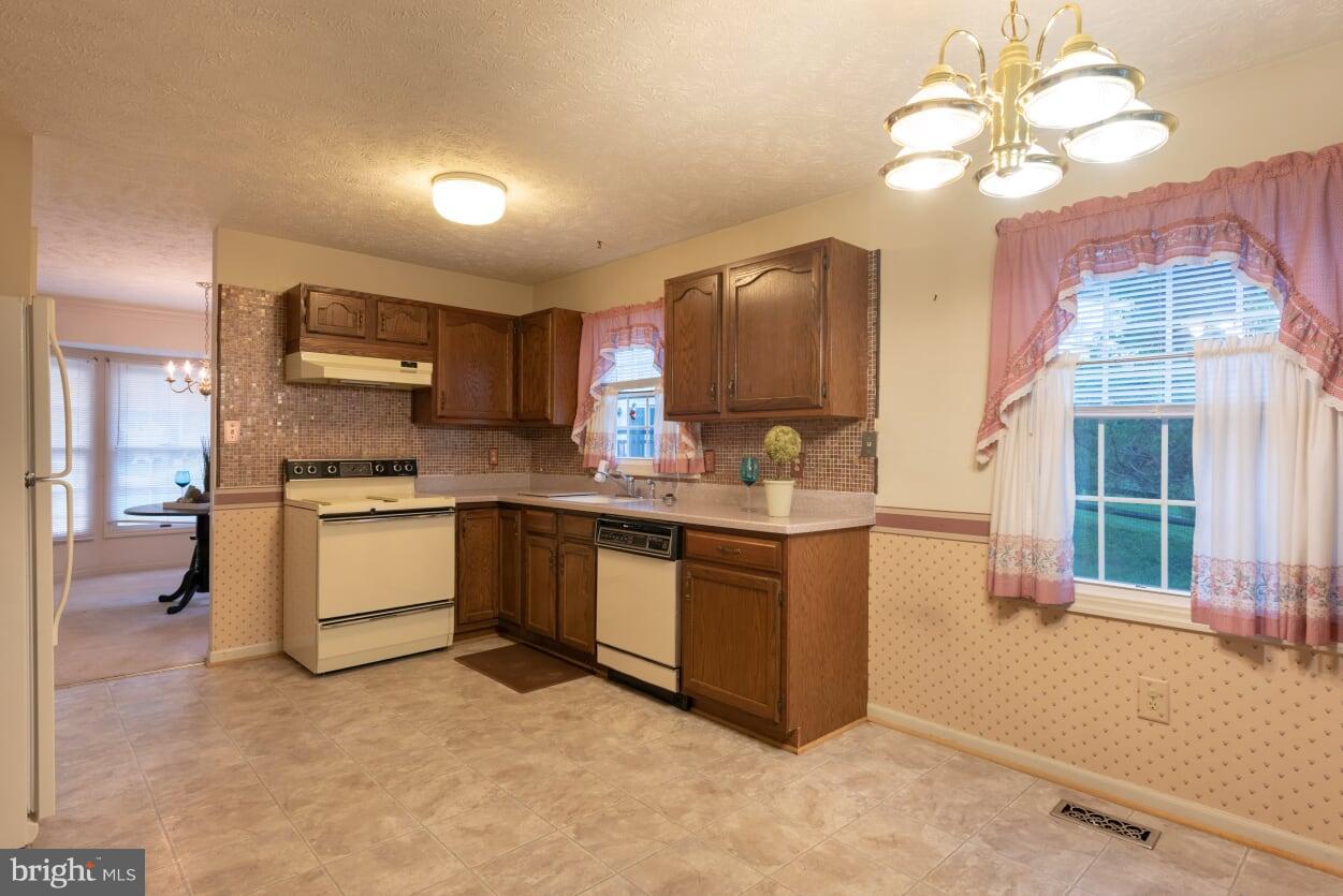 2216 Halter Lane Reston, VA 20191 - Photo 8 of 23 a kitchen with a sink stove and cabinets