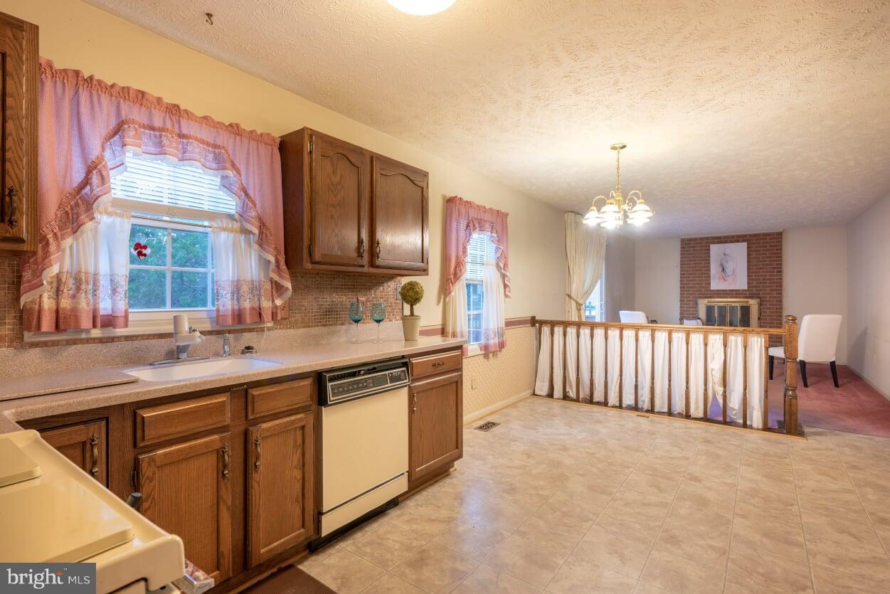2216 Halter Lane Reston, VA 20191 - Photo 9 of 23 a large kitchen with kitchen island granite countertop a large window and a sink