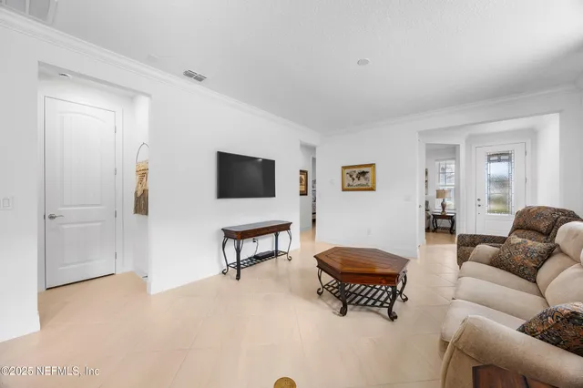 a large kitchen with kitchen island granite countertop lots of white cabinets appliances and furniture