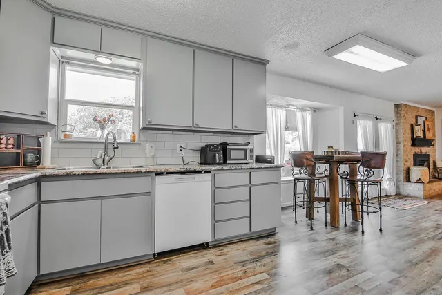 a kitchen with sink cabinets and dining table chair
