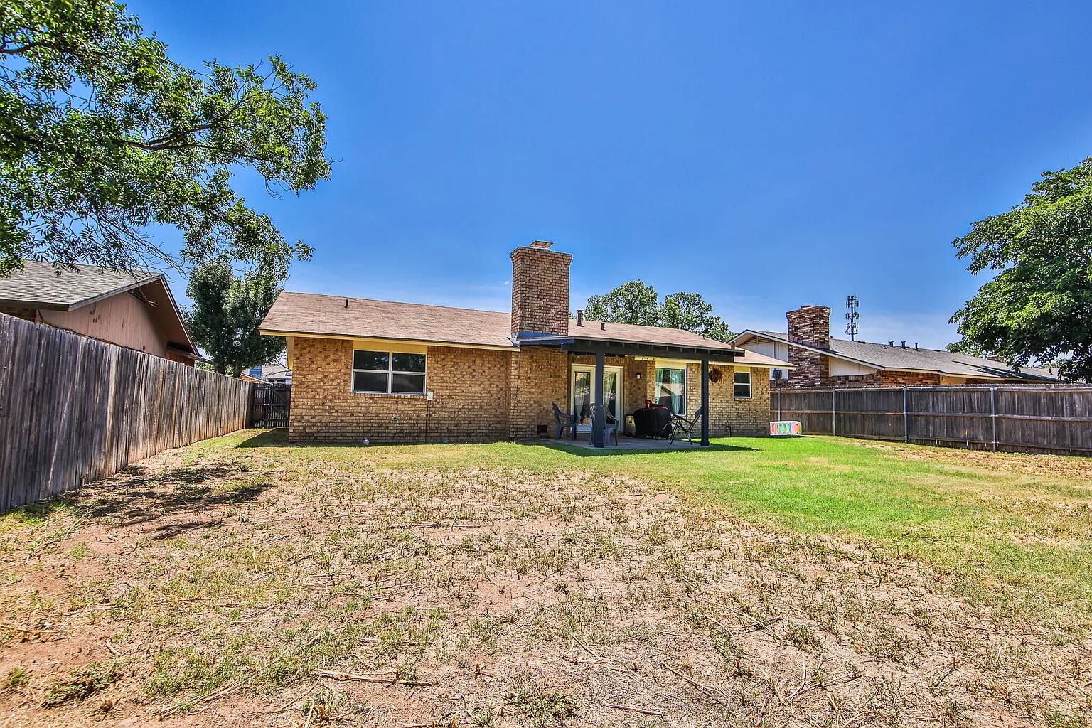5708 3rd Street Lubbock, TX 79416 - Photo 13 of 23 a front view of a house with a yard and pathway
