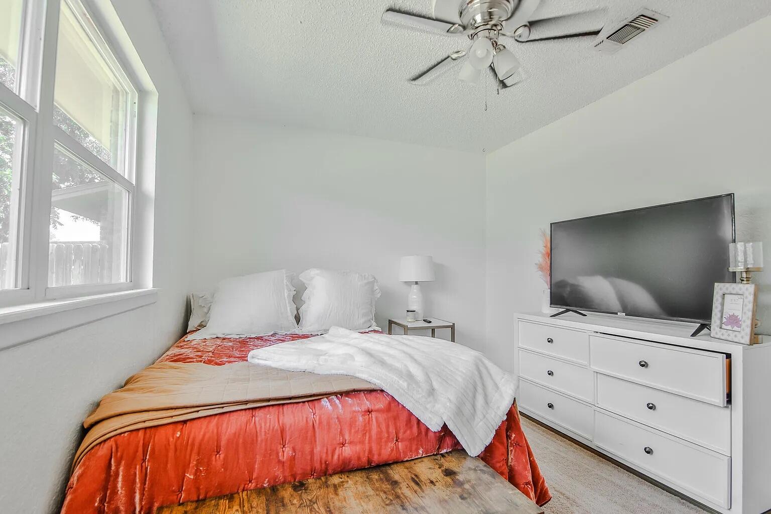5708 3rd Street Lubbock, TX 79416 - Photo 15 of 23 a bedroom with a bed and a flat screen tv