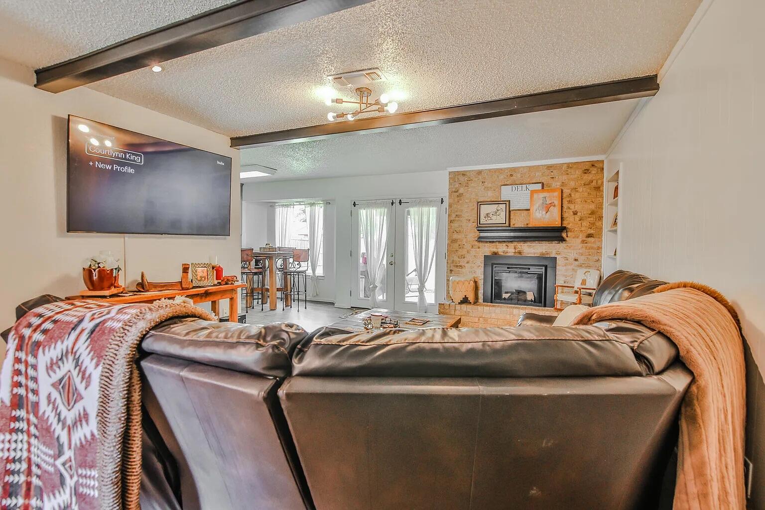 5708 3rd Street Lubbock, TX 79416 - Photo 16 of 23 a bed room with a bed and a television