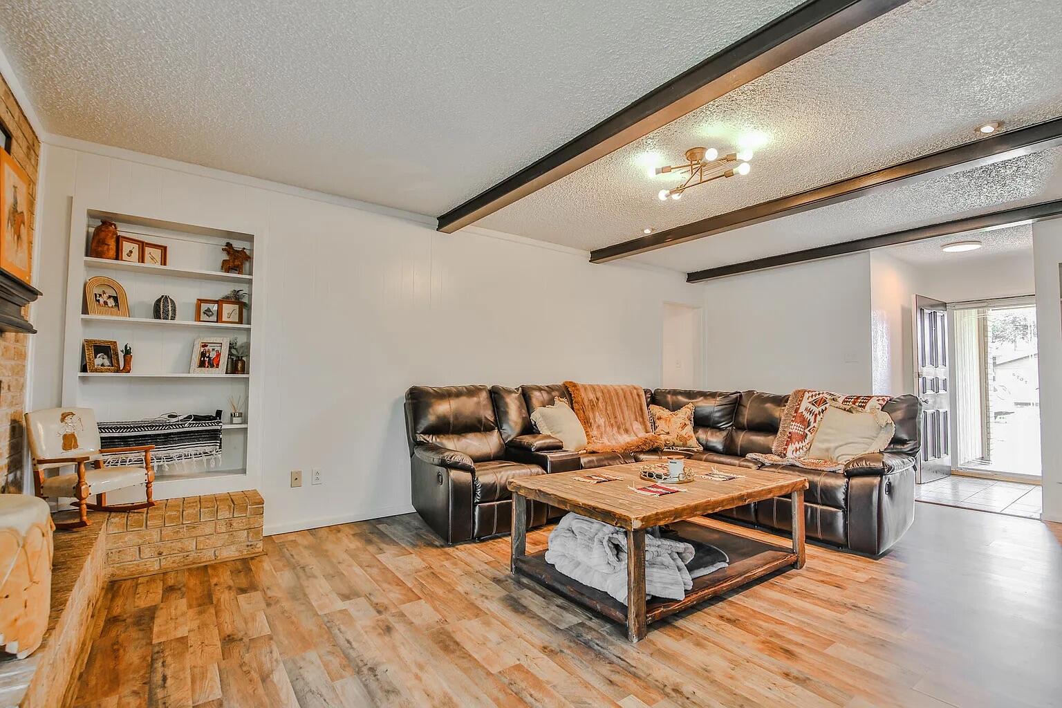 5708 3rd Street Lubbock, TX 79416 - Photo 17 of 23 a living room with furniture and wooden floor