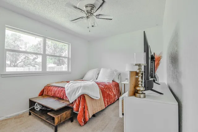 a bedroom with bed and window