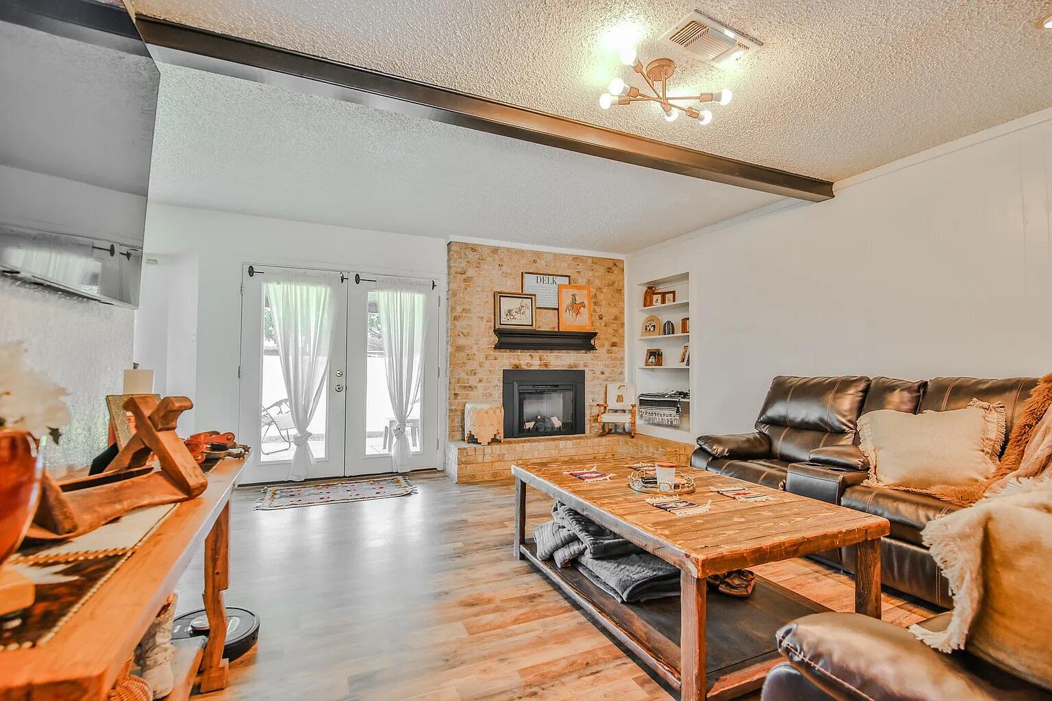 5708 3rd Street Lubbock, TX 79416 - Photo 4 of 23 a living room with fireplace furniture and a large window