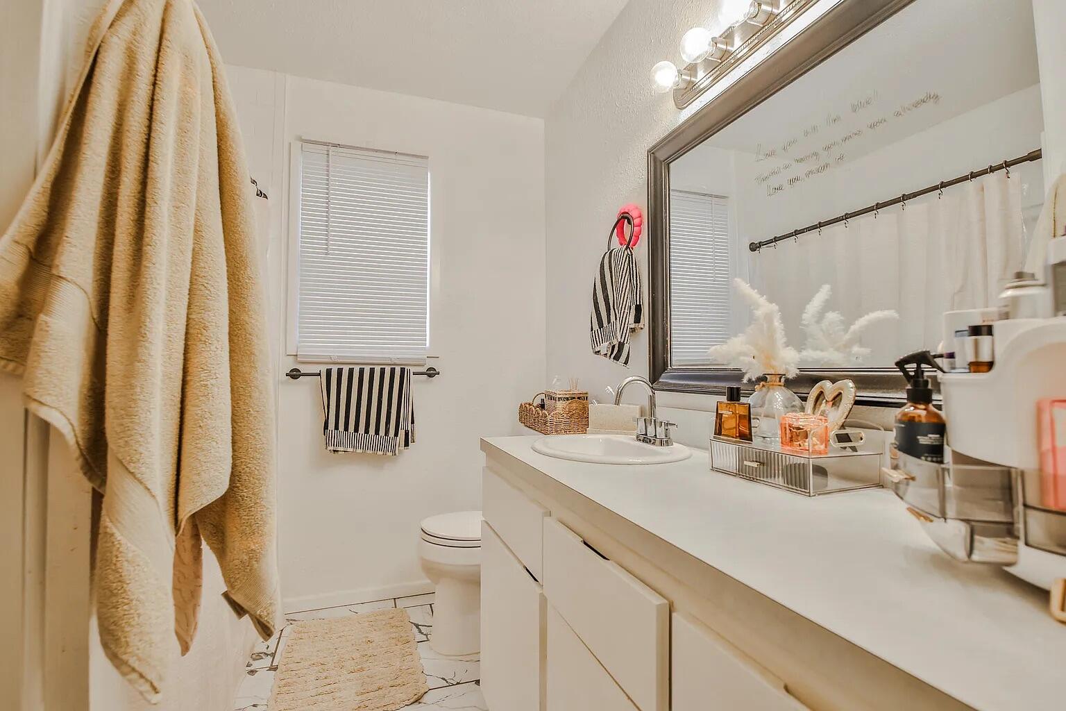 5708 3rd Street Lubbock, TX 79416 - Photo 5 of 23 a bathroom with a sink mirror vanity and toilet