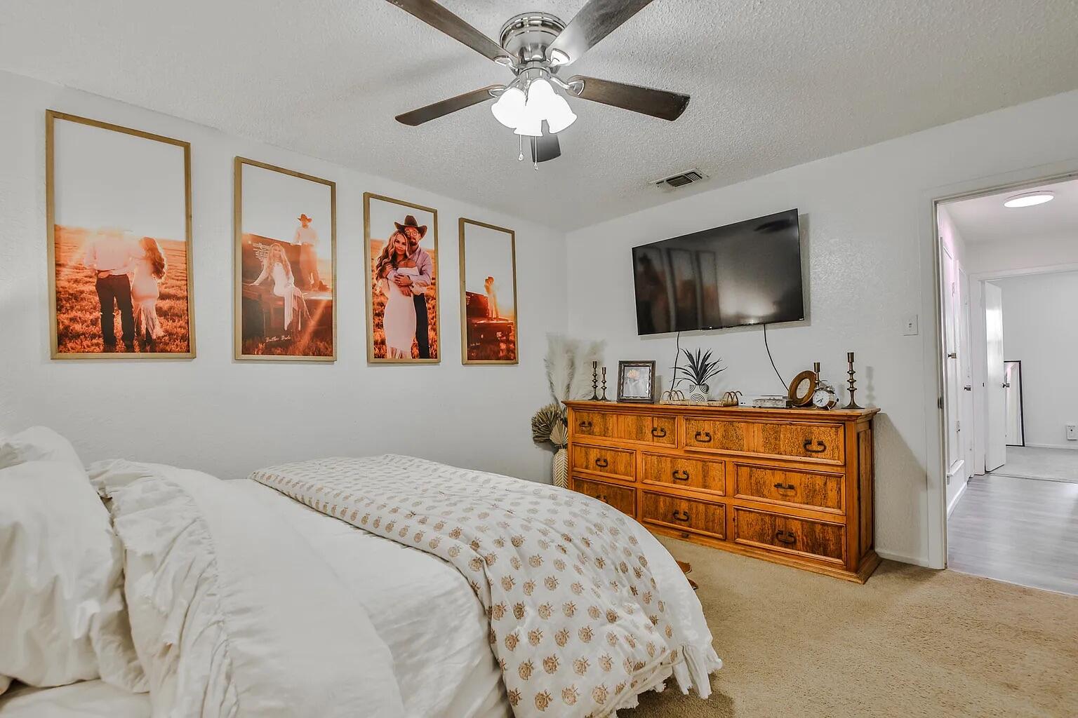 5708 3rd Street Lubbock, TX 79416 - Photo 6 of 23 a bedroom with a bed and a flat screen tv
