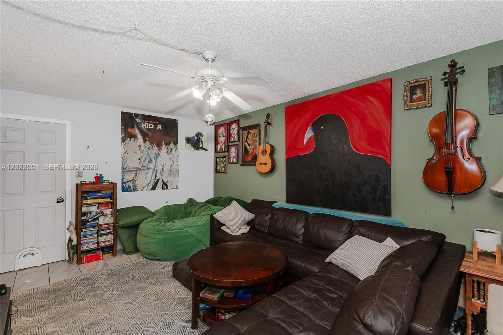 11482 Southwest 109th Road, Unit 29A Miami, FL 33176 - Photo 12 of 28 a living room with furniture a rug and a chandelier