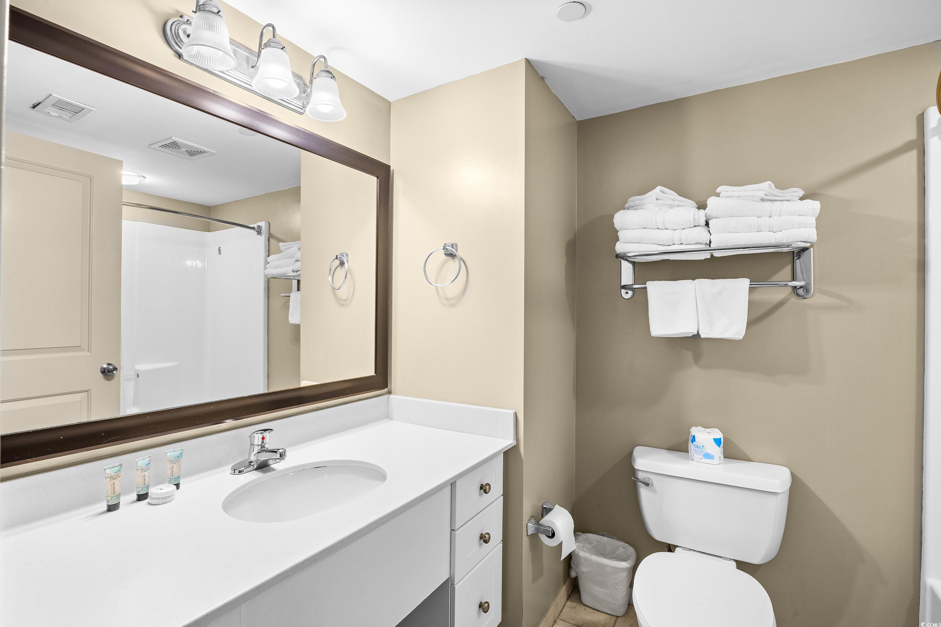 107 Ocean Boulevard, Unit 1402 Myrtle Beach, SC 29577 - Photo 14 of 38 Full bathroom with toilet, vanity, visible vents, and a shower