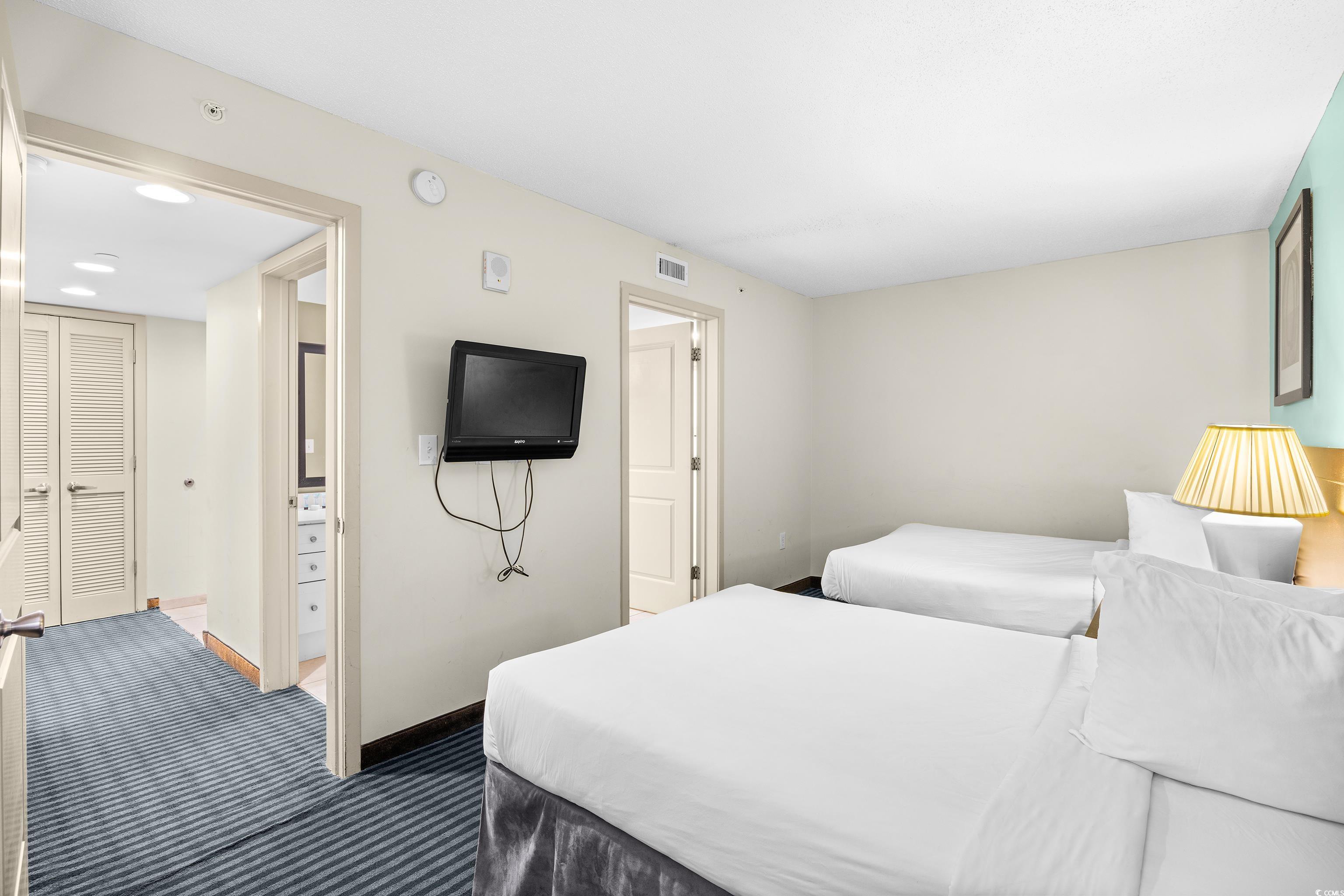 107 Ocean Boulevard, Unit 1402 Myrtle Beach, SC 29577 - Photo 15 of 38 Bedroom with baseboards, dark colored carpet, and visible vents