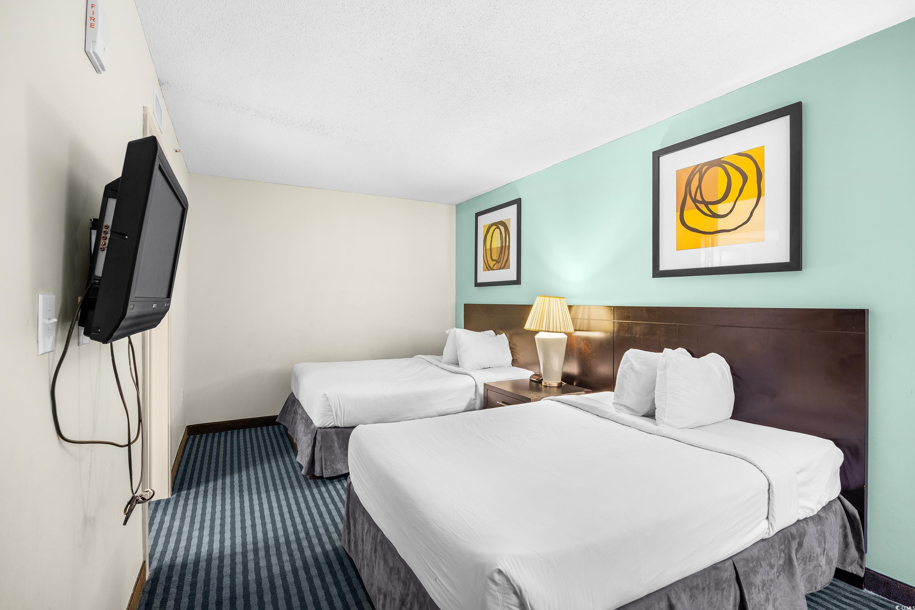 107 Ocean Boulevard, Unit 1402 Myrtle Beach, SC 29577 - Photo 17 of 38 Carpeted bedroom featuring a textured ceiling and baseboards