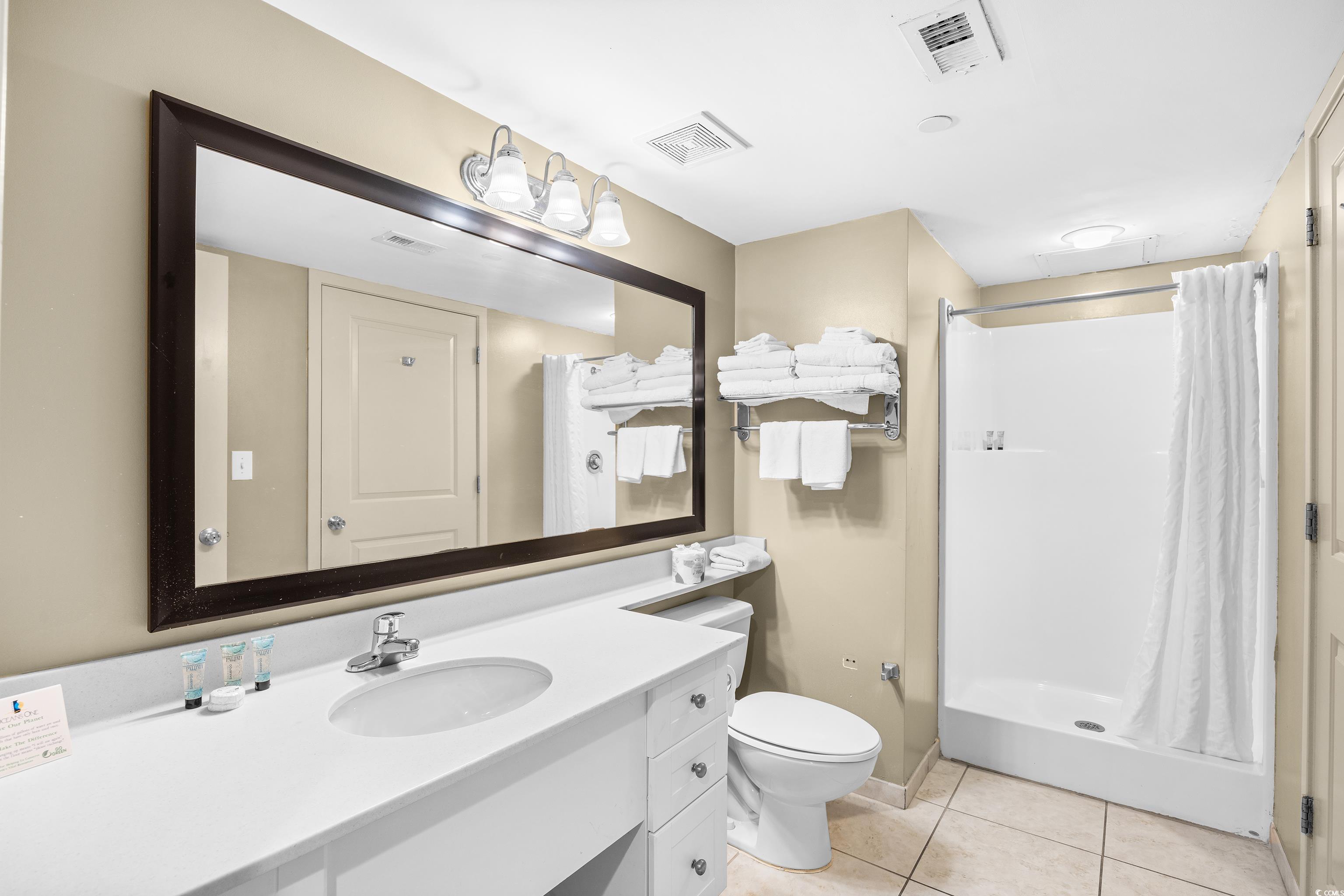 107 Ocean Boulevard, Unit 1402 Myrtle Beach, SC 29577 - Photo 19 of 38 Full bath with a stall shower, tile patterned floors, vanity, and visible vents