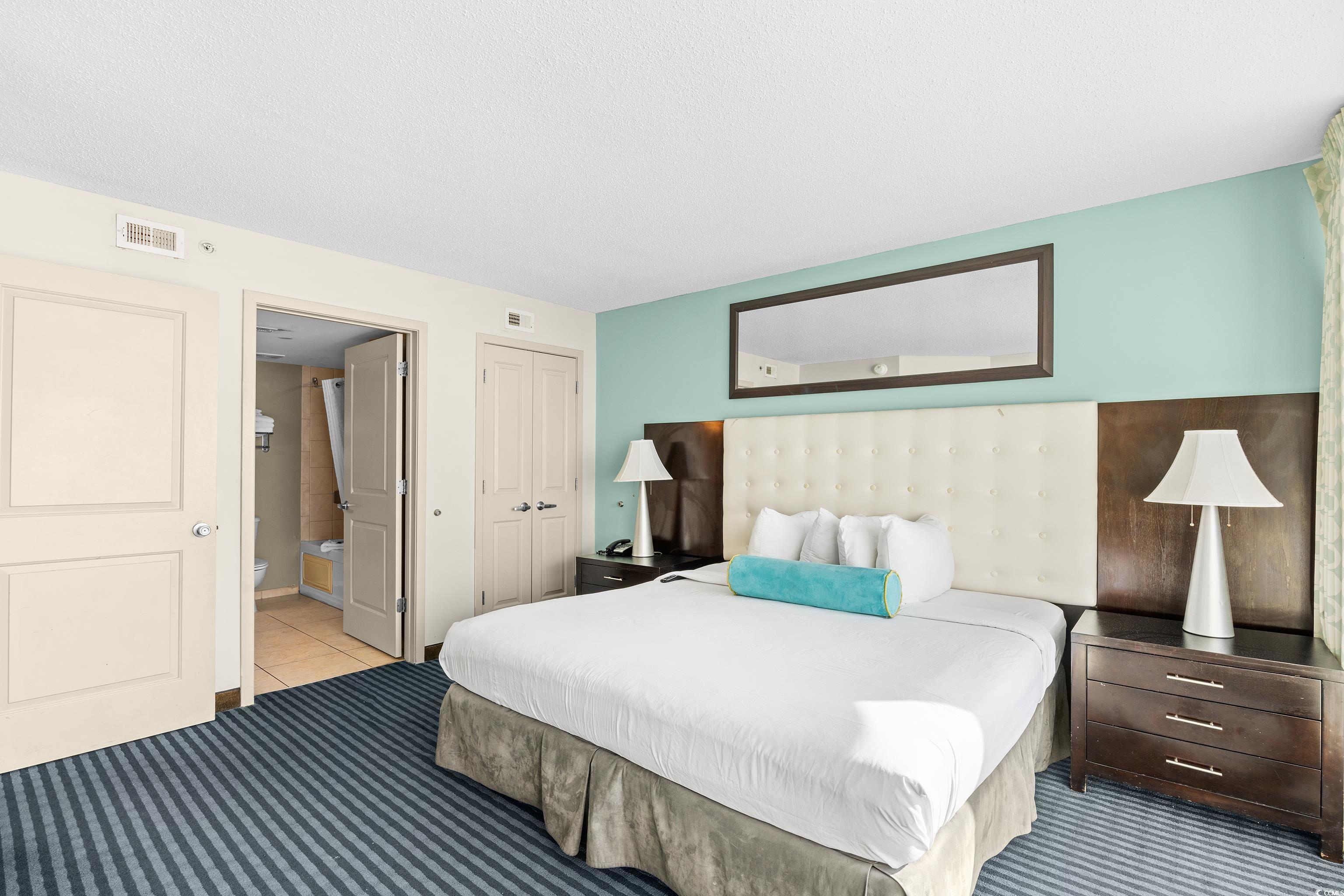 107 Ocean Boulevard, Unit 1402 Myrtle Beach, SC 29577 - Photo 22 of 38 Bedroom with tile patterned flooring, a closet, connected bathroom, and visible vents
