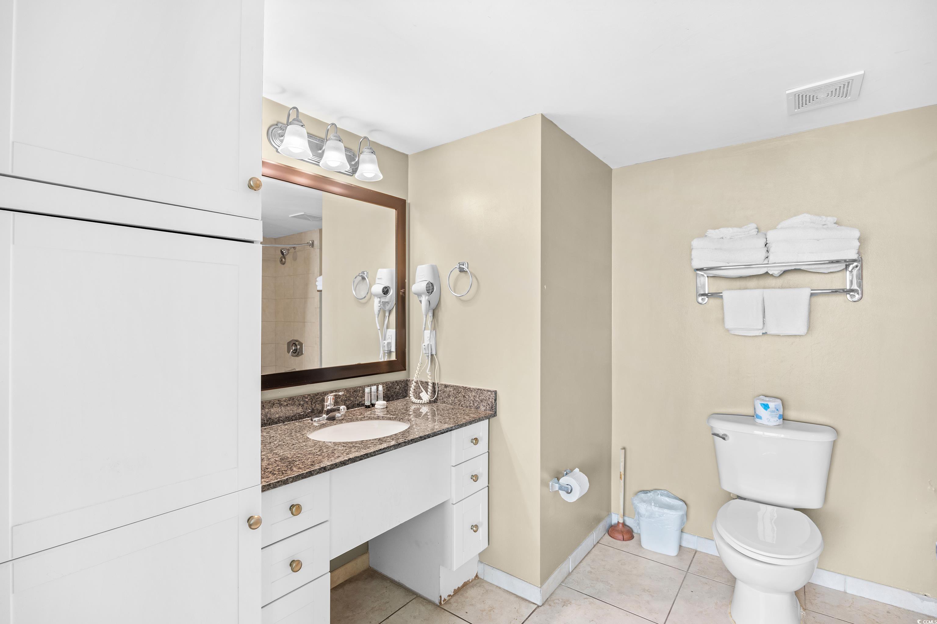107 Ocean Boulevard, Unit 1402 Myrtle Beach, SC 29577 - Photo 23 of 38 Full bath with toilet, vanity, visible vents, tile patterned floors, and baseboards