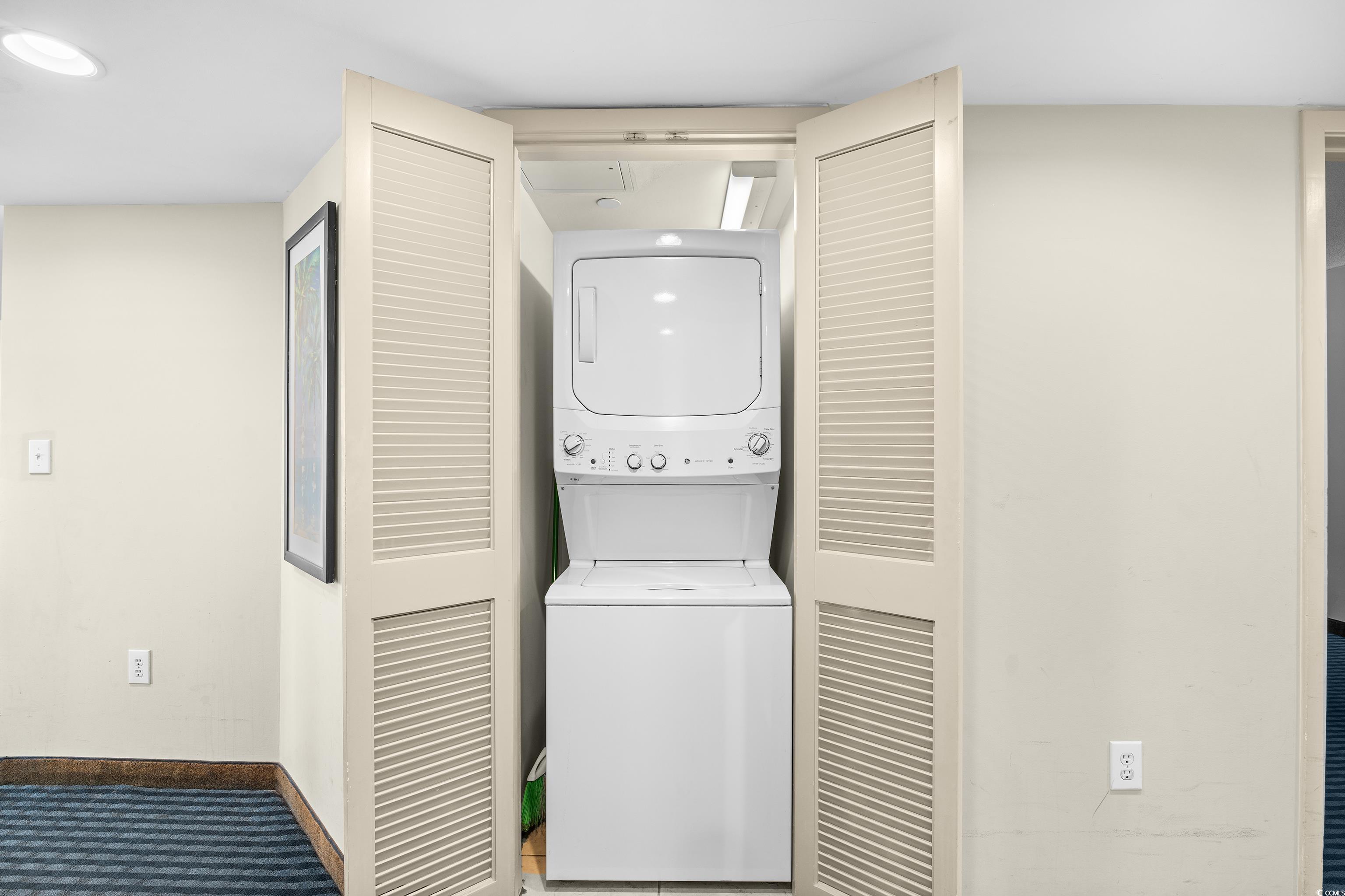 107 Ocean Boulevard, Unit 1402 Myrtle Beach, SC 29577 - Photo 25 of 38 Laundry area with laundry area, carpet flooring, stacked washer and dryer, and baseboards