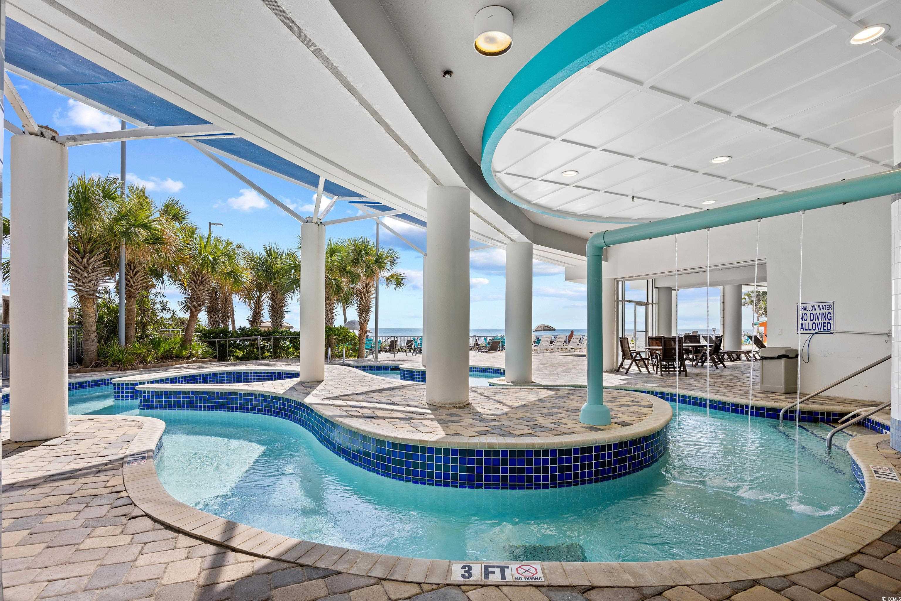 107 Ocean Boulevard, Unit 1402 Myrtle Beach, SC 29577 - Photo 30 of 38 Pool featuring a community hot tub and a patio