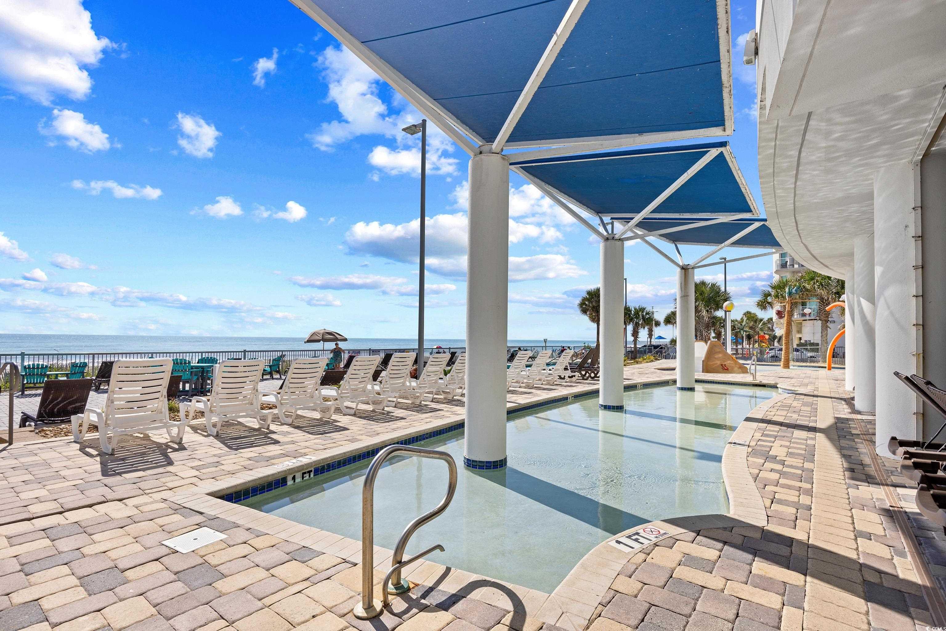 107 Ocean Boulevard, Unit 1402 Myrtle Beach, SC 29577 - Photo 32 of 38 View of swimming pool featuring a patio and a water view