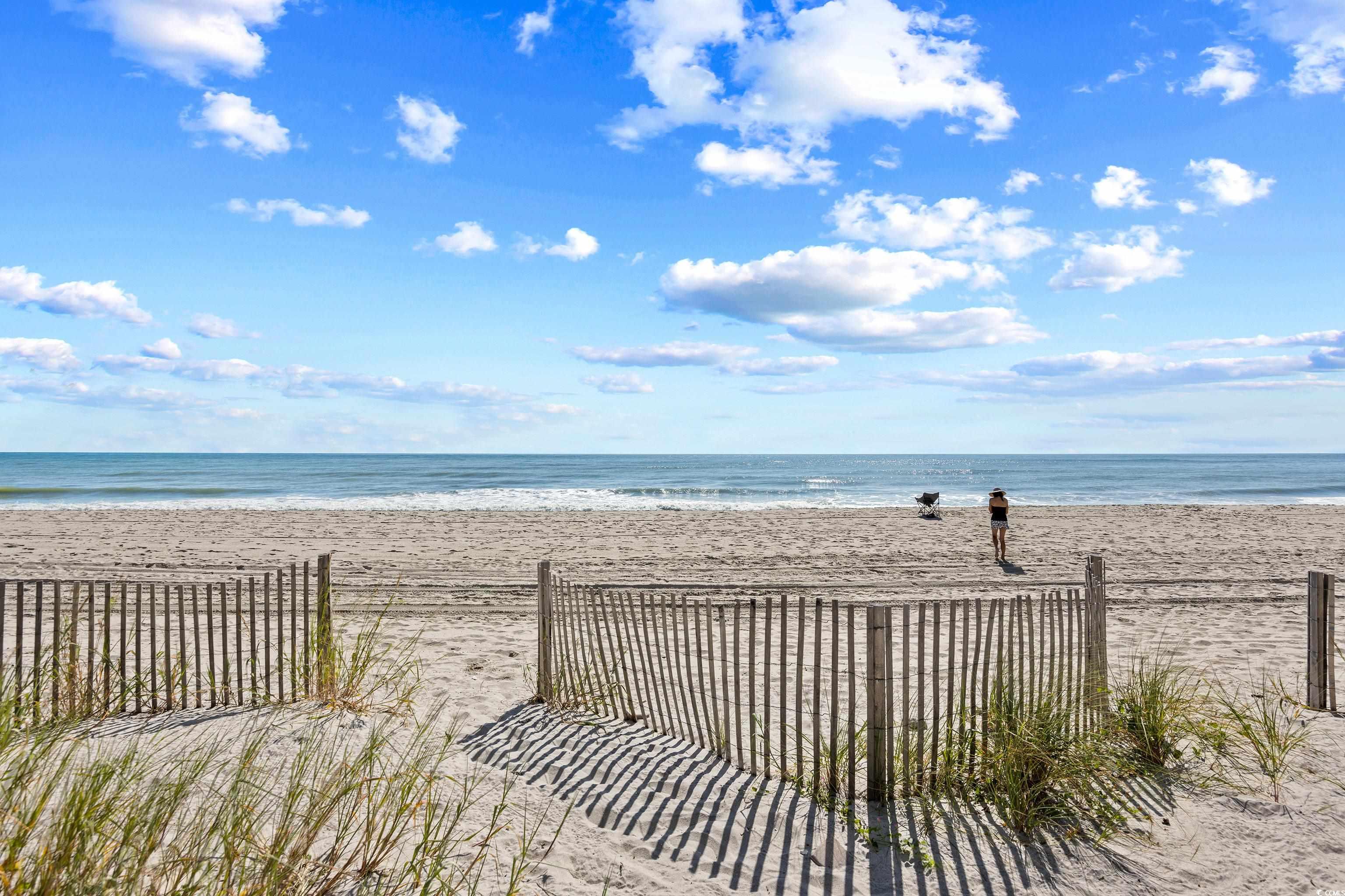 107 Ocean Boulevard, Unit 1402 Myrtle Beach, SC 29577 - Photo 34 of 38 View of water feature with fence and a view of the beach