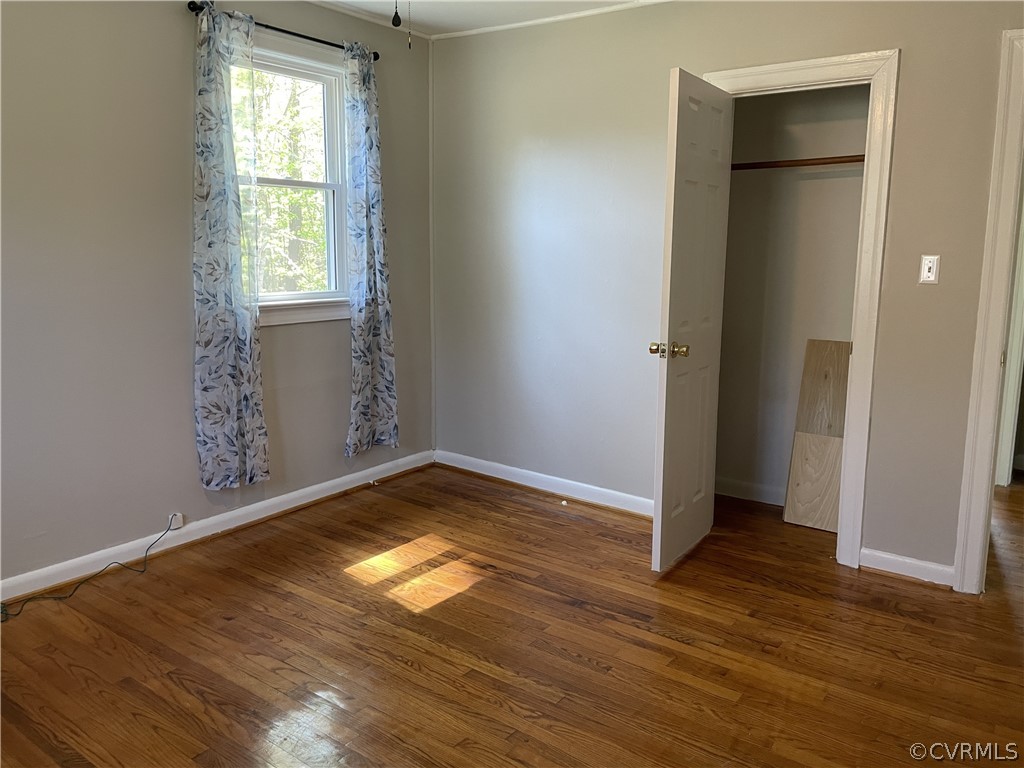 228 Beech Forest Road Kenbridge, VA 23944 - Photo 19 of 23 an empty room with wooden floor and windows